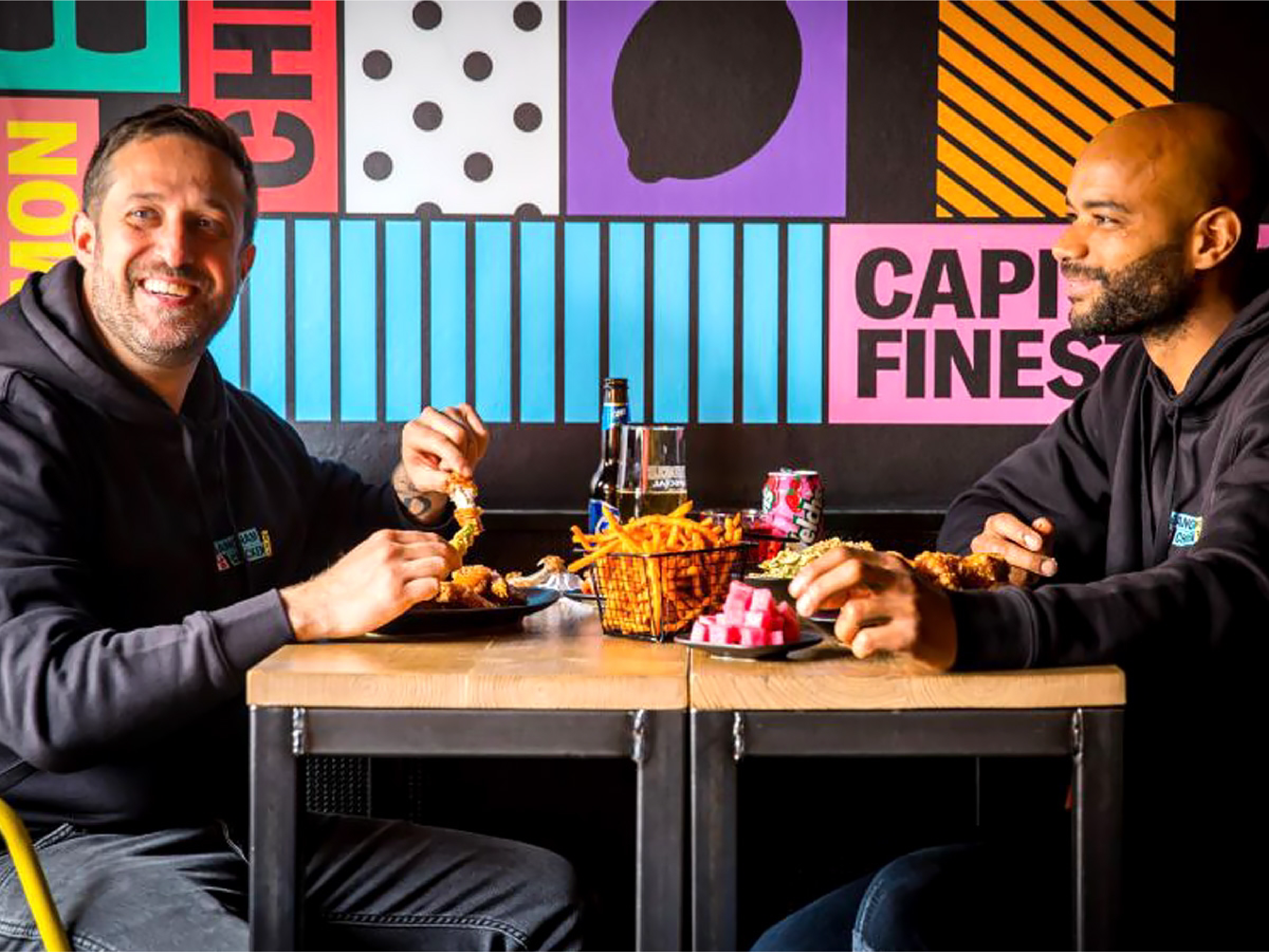 Twee mannen die in een Gangnam Chicken Shop eten